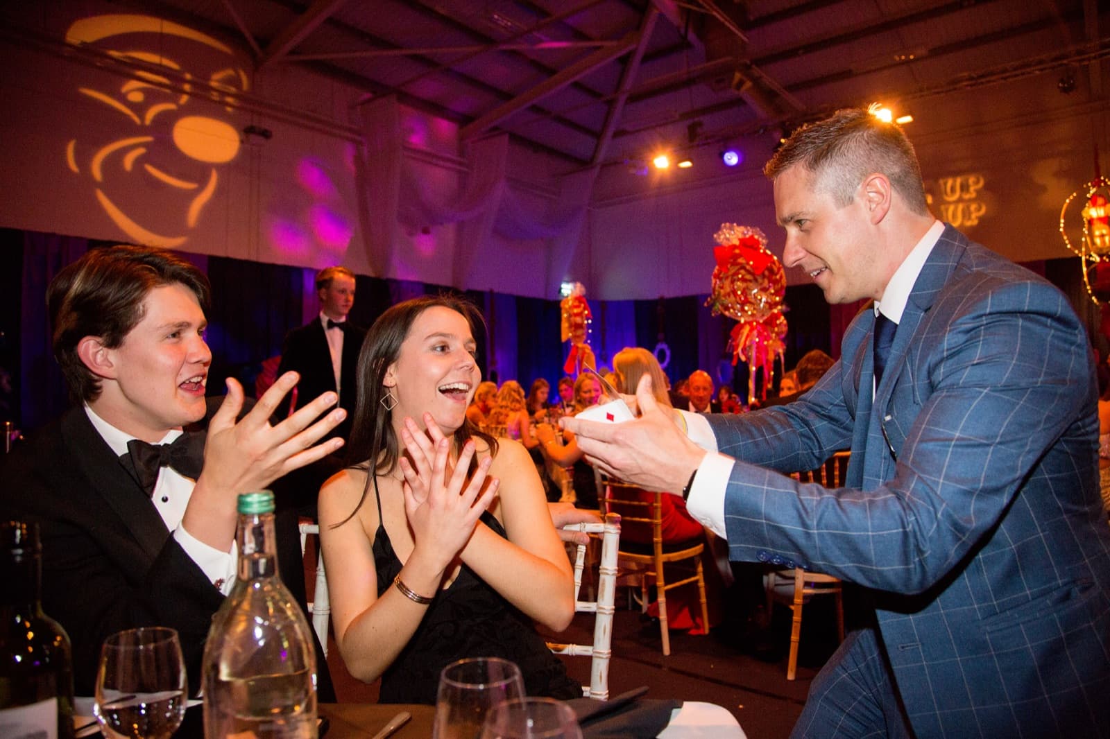 Card reveal at corporate gala